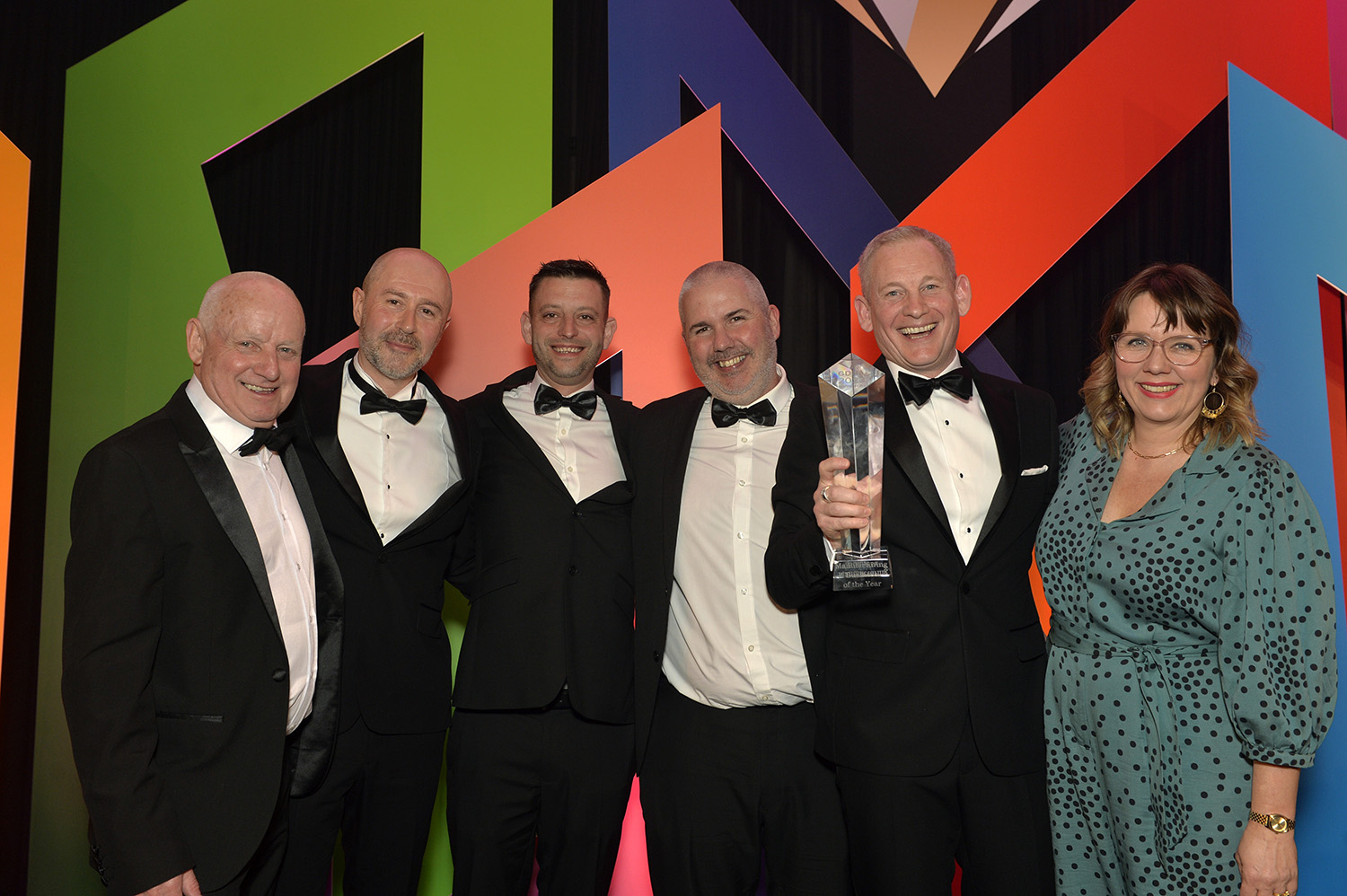 Four members of the Bakers team showcasing their trophy from winning the Manufacturer of the Year award
