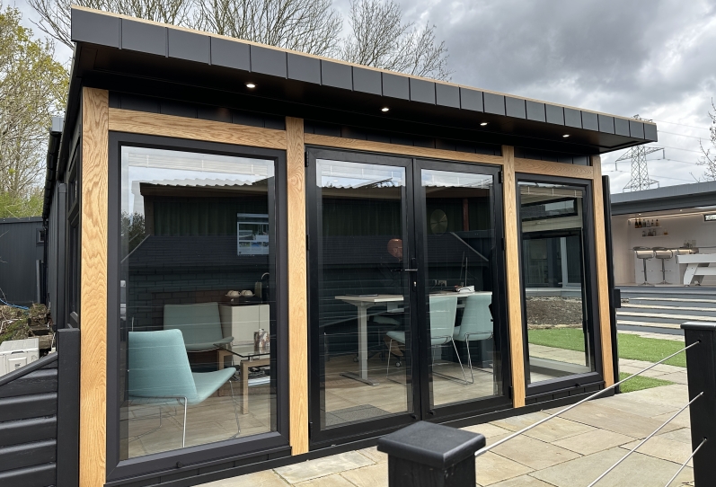 black summerhouse  with oak trims  at Bakers Garden Buildings