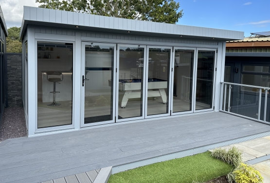 Bi-fold with roof light, integrated blinds, pop up TV and feature wall storage with bar in Haywards Heath