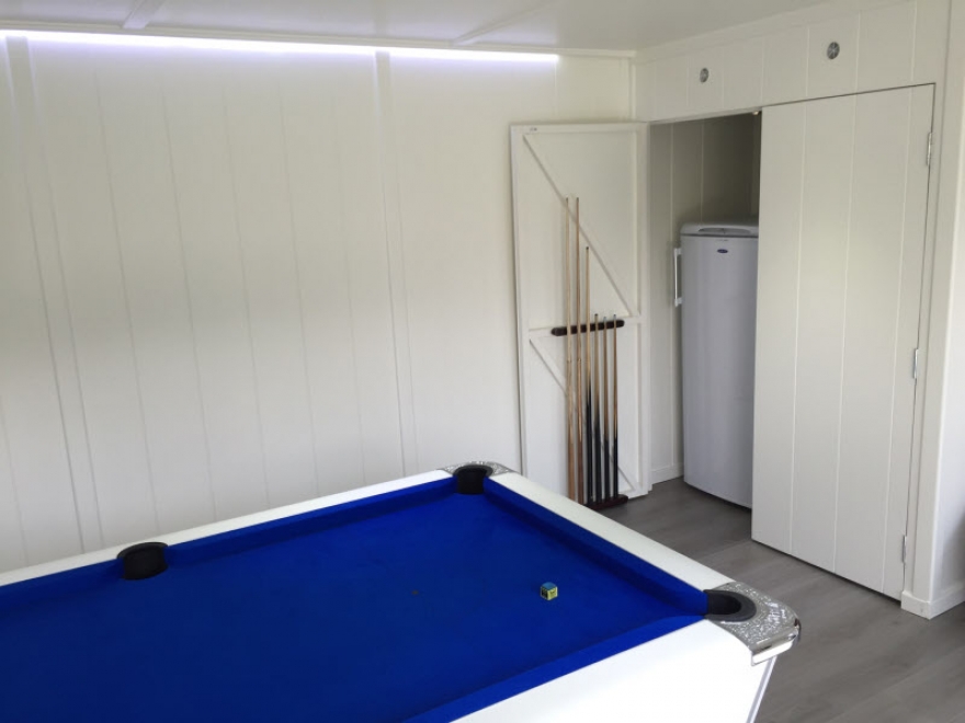 Pool table,and cupboard for fridge freezer and pool ques store