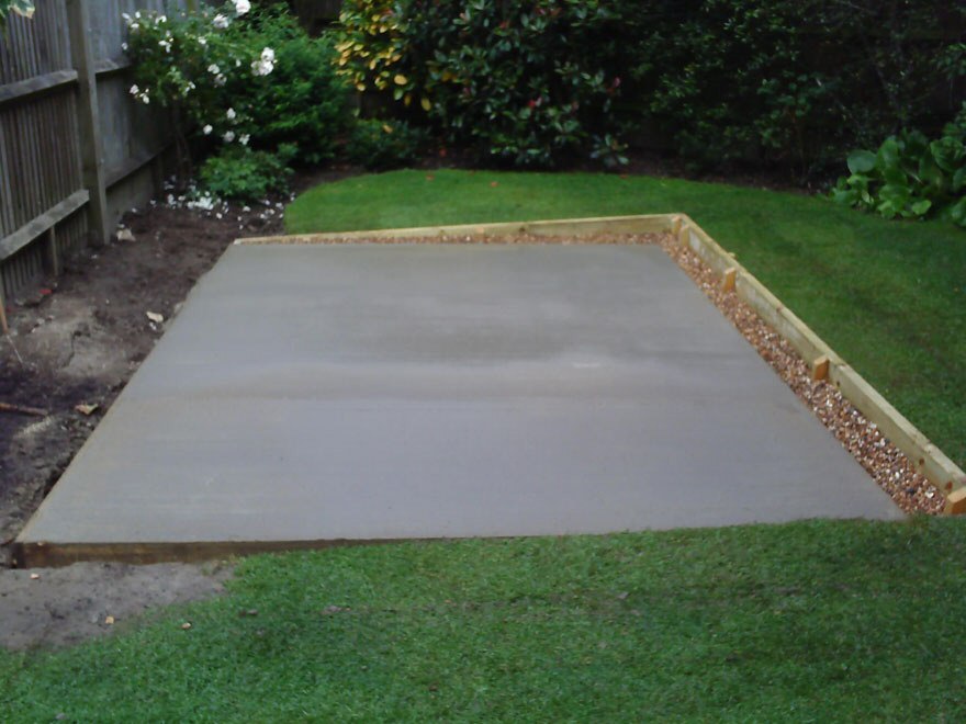 Concrete base with retaining wall