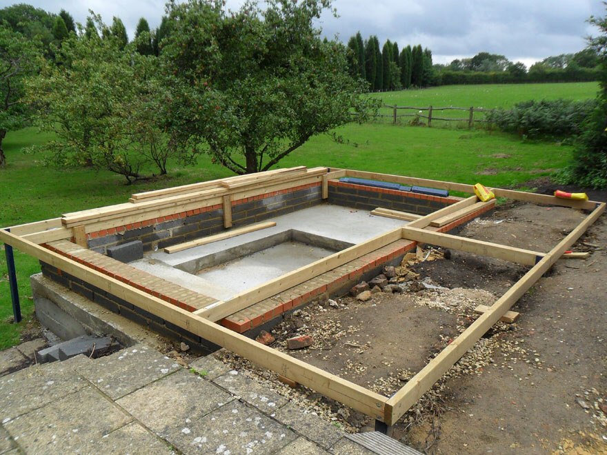 Raised base in garden that is stepped down from the house