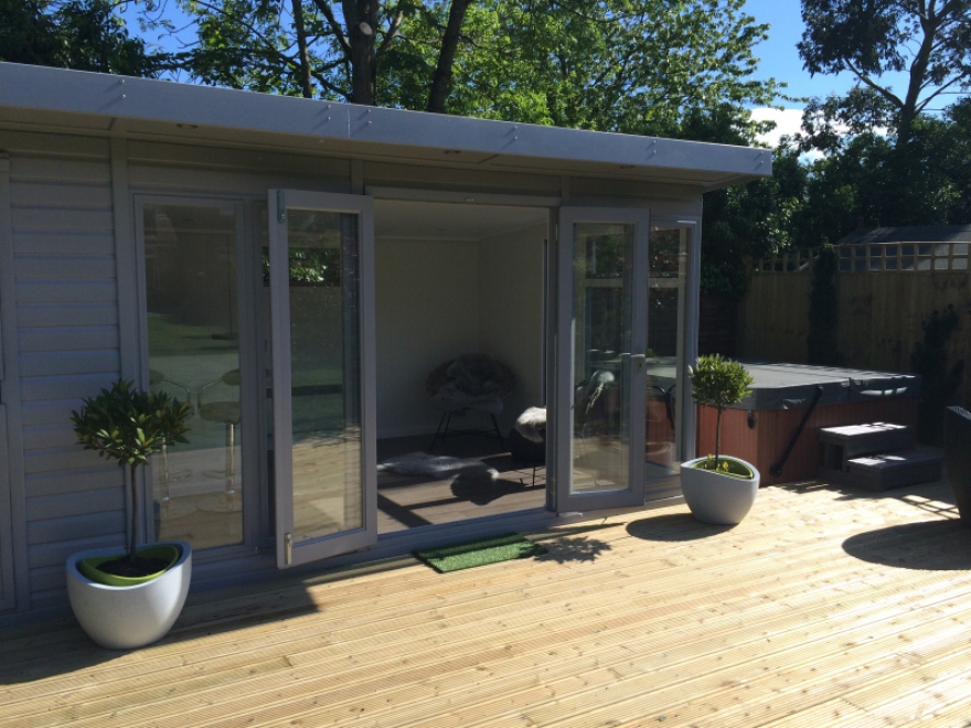 Combination garden room with large decked area to front of building