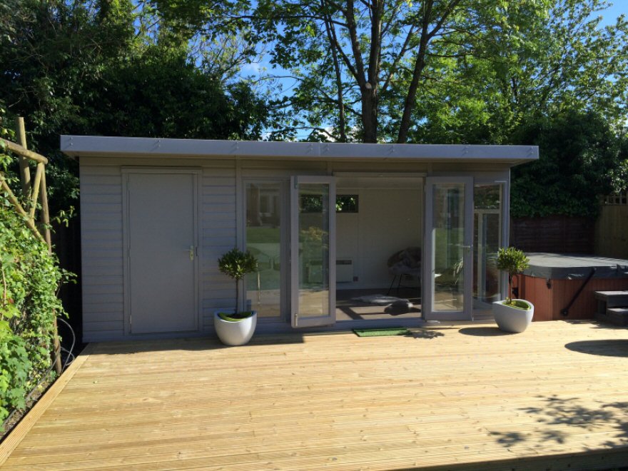 Combination garden room with large decked area to front of building