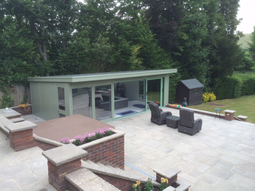 7m x 4,25m summer house with EndlessÂ® pool room featuring aluminium tri-sliding doors
