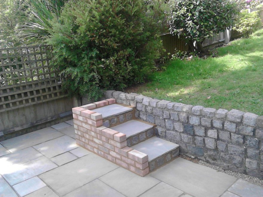 Our installation team laid the patio and stone steps for access to the upper tier of the garden