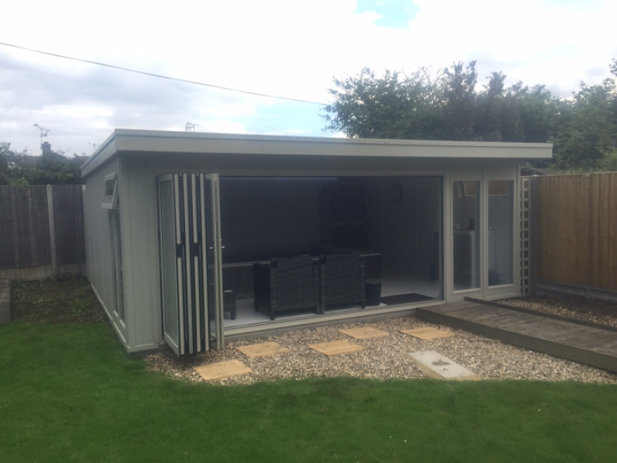 This building features 4,2m  wide aluminium bi-folding doors in RAL 7032 'Pebble Grey' to match the exterior paintwork