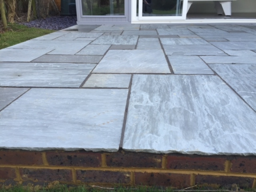 Indian sandstone with pro pointing product in a contrasting dark grey, with brick edging. 