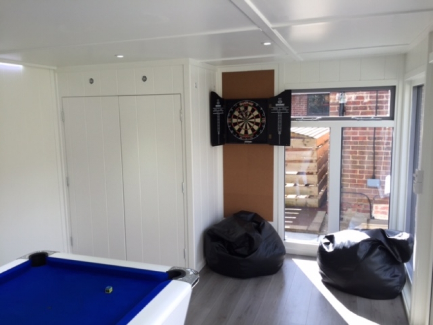 Dart board on protective board. The vent above the flush doors give air flow for the fridge and freezer hidden away