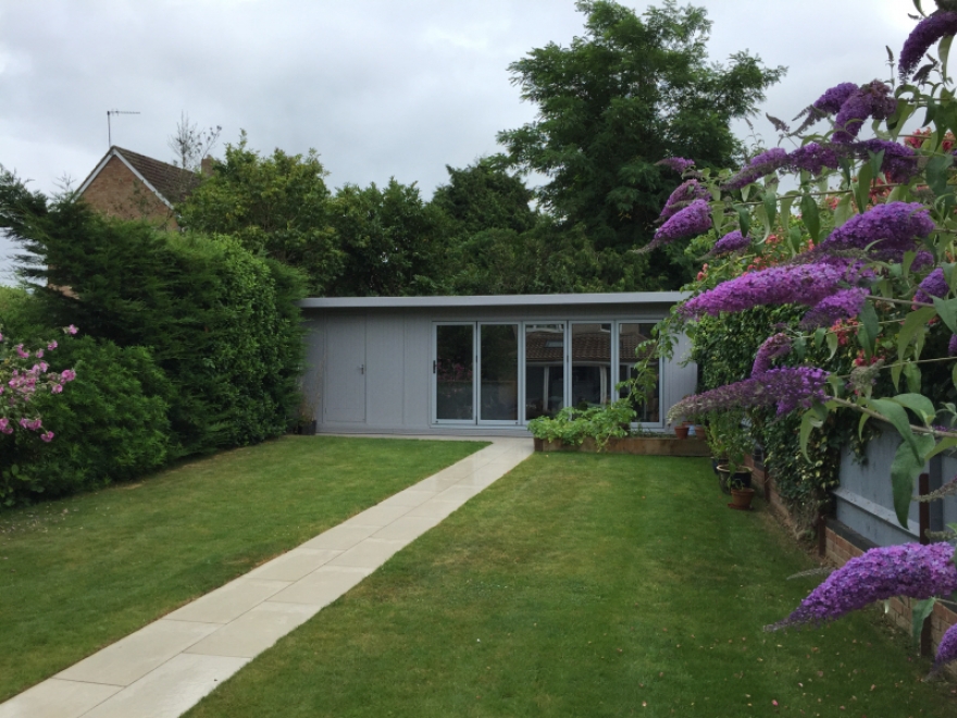 The building is maximizing the width of this modern garden and not only gives a great extension of living space, but also gives the perfect back drop for the property 