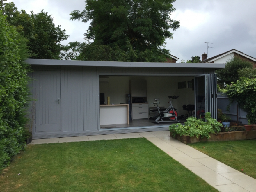 Combination bi-fold and store, in "signal grey", with v-groove cladding and store door