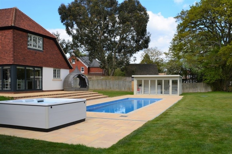 The colour matched poolside summerhouse is fully integrated with the client's stunning garden and property