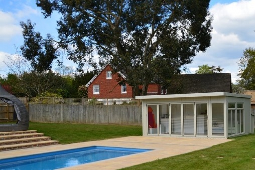 The poolside summer house enables a convenient changing and showering facility