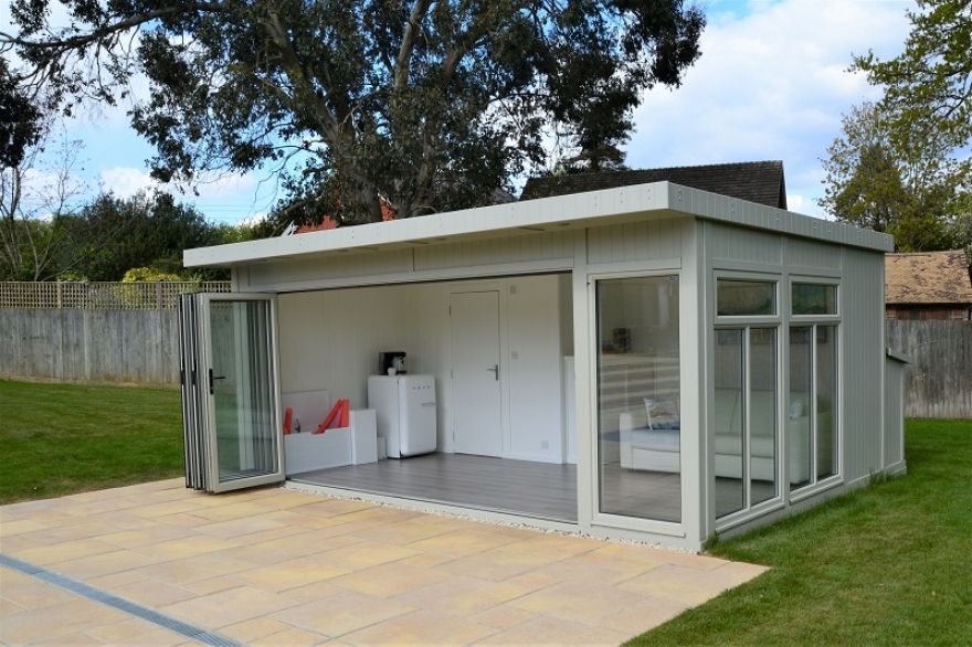 The bi-folding aluminium colour matched doors fold right back to allow for the garden to come into the summerhouse