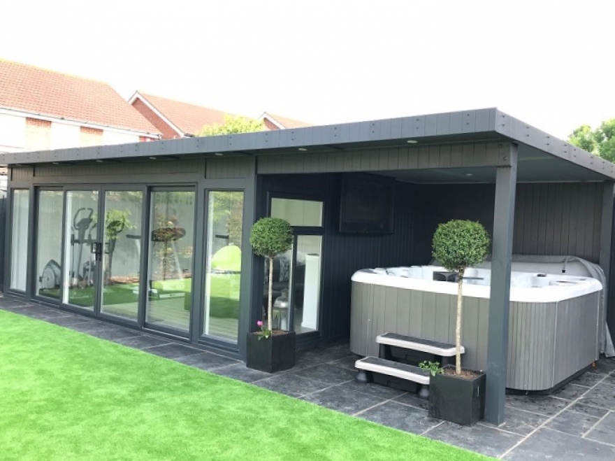 This UPVC sliding door garden home gym with hot tub canopy sits elegantly within our client's garden.