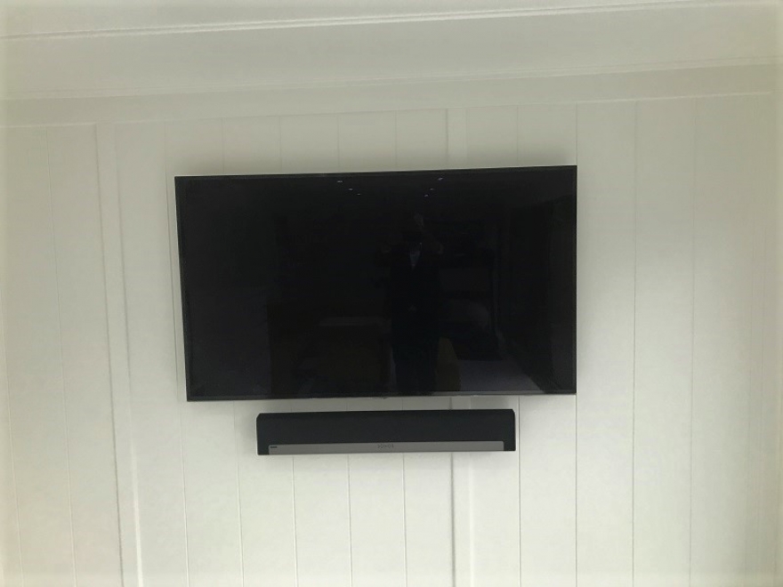 The wires are neatly concealed behind this TV with sound bar