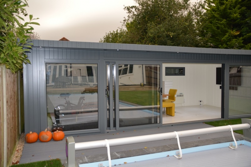 The composite decking installed between the poolside garden room and the Clients pool is a practical alternative to grass