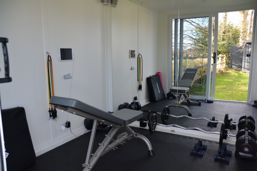 This compact gym is fitted with mirrors to reflect the light - making the room feel twice its size.