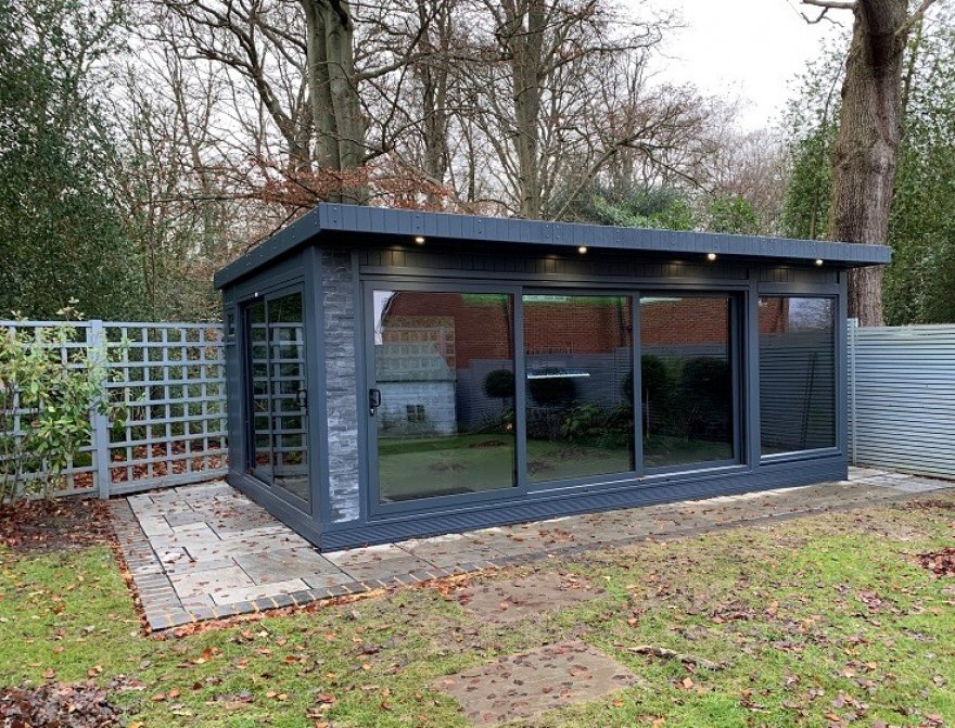 Garden office featuring tri-sliding aluminium doors to the front and sliding doors to the side