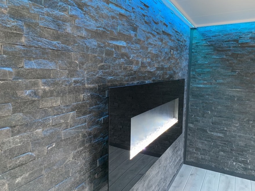 feature fireplace mounted on split faced tiled walls