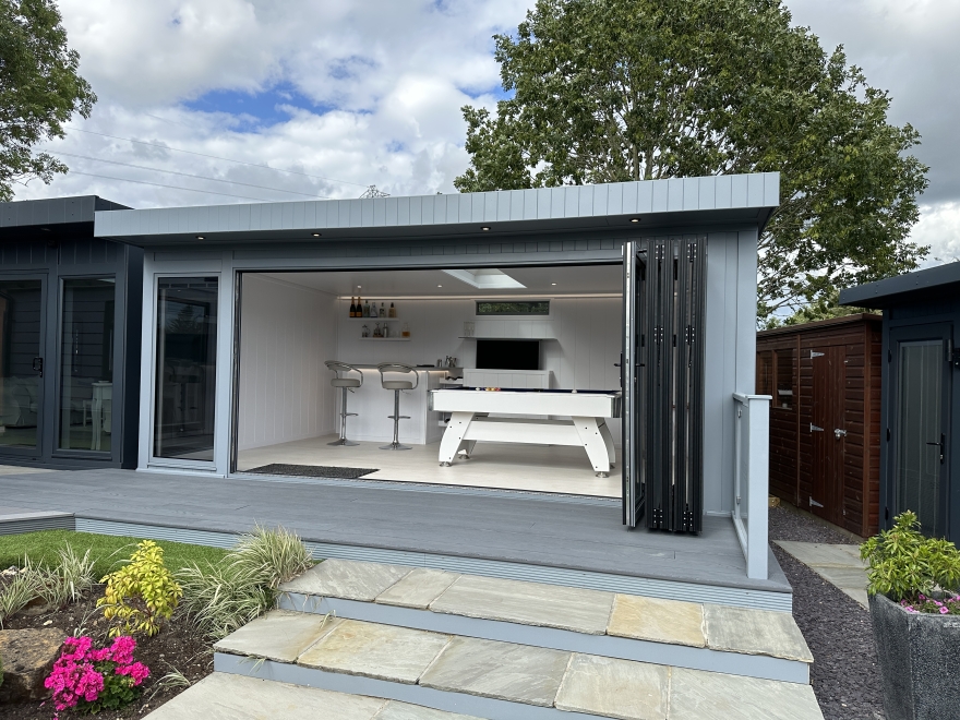 Contemporary garden summer house with bi-fold aluminium doors - the ultimate in outdoor living. Fully lined and insulated, you can enjoy it all year-round. 