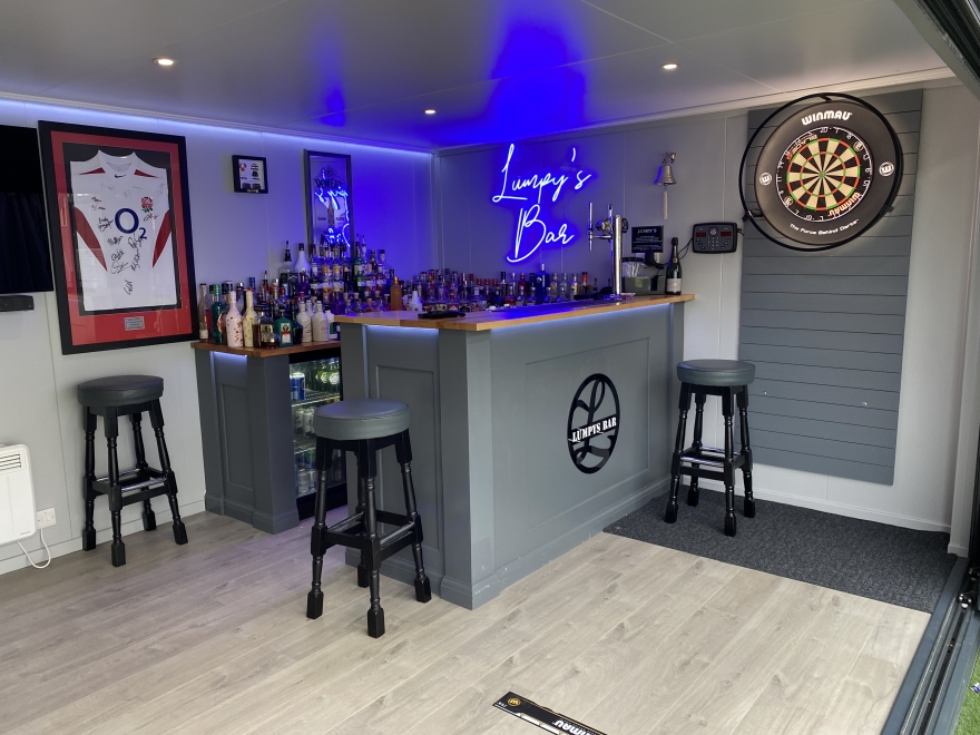 bi-fold game room with bar and dart board