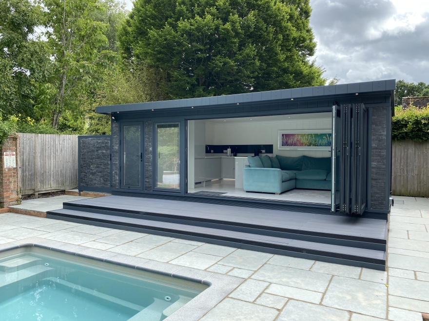 bi-fold self contained pool side room with, kitchen, shower room, changing room and stone cladding 