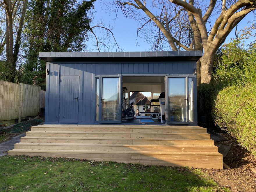 Outside of a garden building with external storage room being used as a garden gym