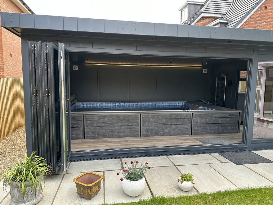 endless pool room with bi-fold doors and grey interior 