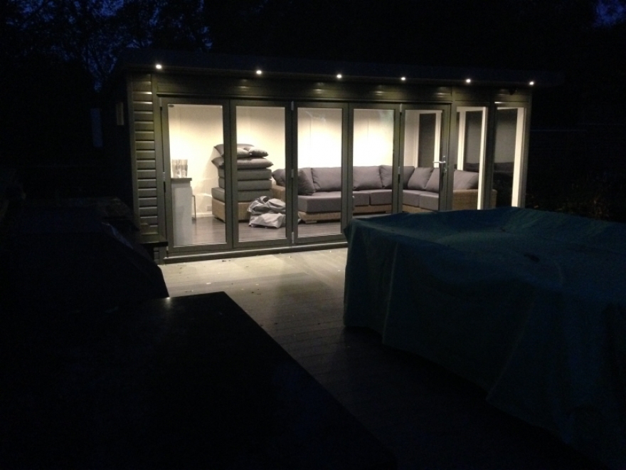 Garden room lit up at night with external downlights