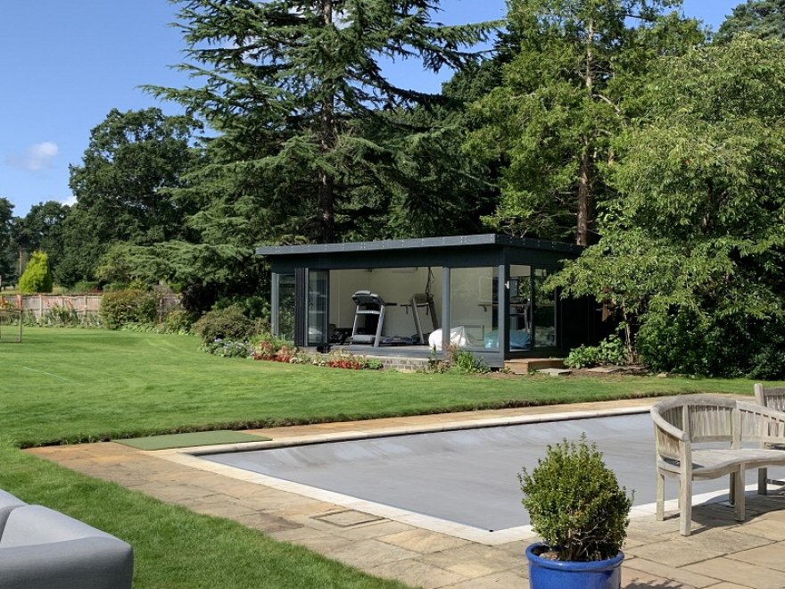 Gym / Dance Studio / Garden Room with Aluminium Bi-fold and Sliding Doors in RAL 7016 Antracite Installed in Woking