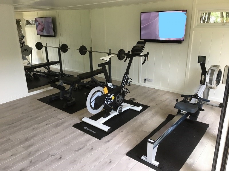 man cave with gym and mirrors in the wall London 