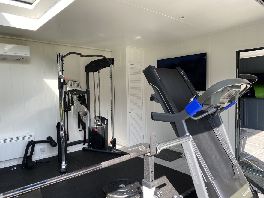 garden gym with storage cupboard, tv and multi gym