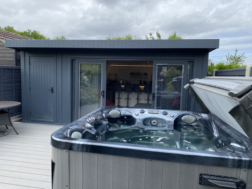 man cave with bar, TV and hot tub Kent 