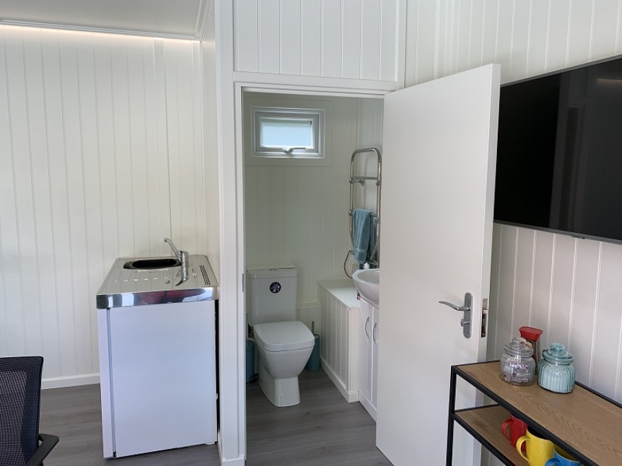 Lovely Compact Toilet Room along with Small Kitchenette with Hot Water Storage Tank Installed in Tadworth Surrey