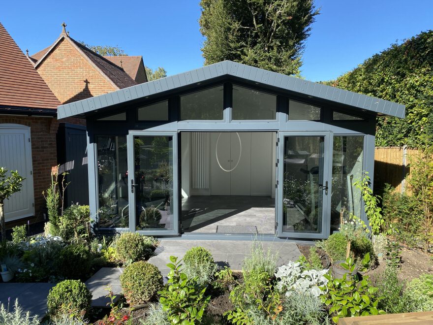 Outside of a garden building being used as a fitness studio for yoga, aerial acrobatics and home gym
