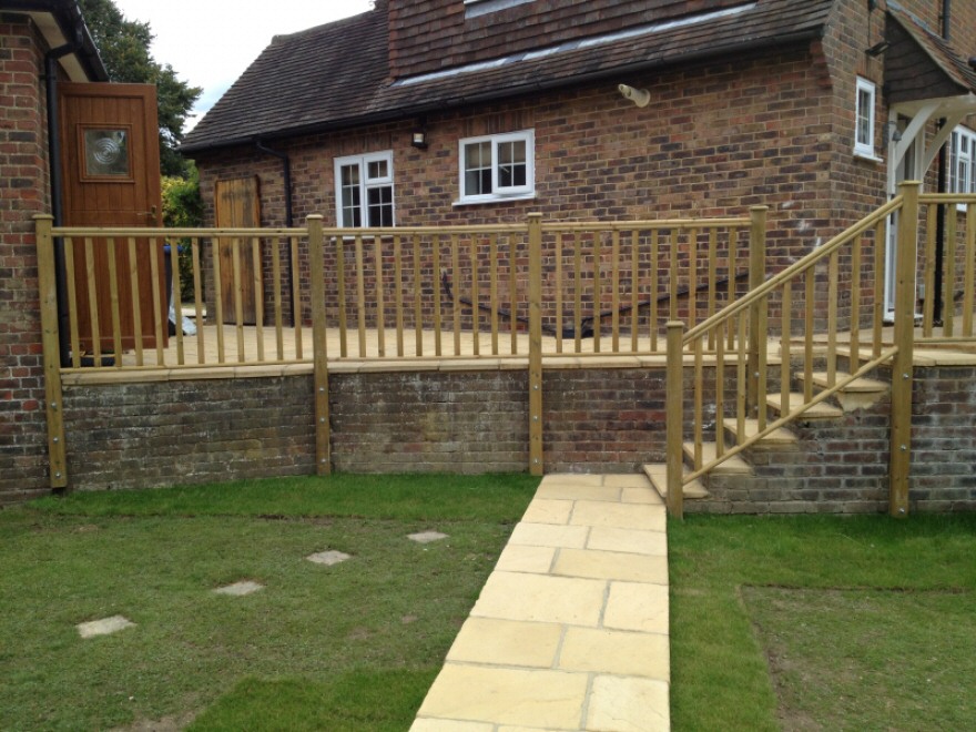 New sandstone patio with balustrade to front, leading to verandha and steps.