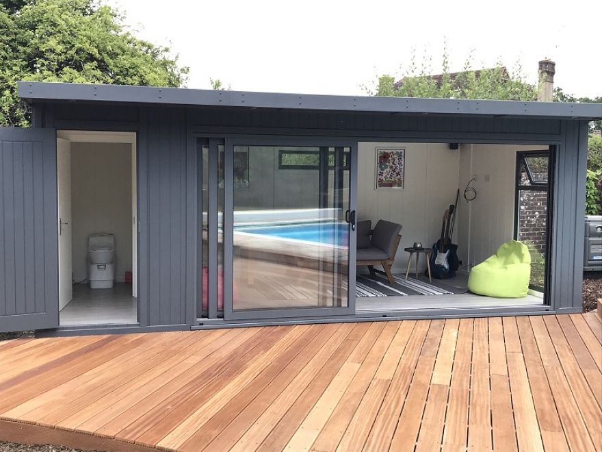 Contemporary garden summer house with tri-sliding aluminium doors