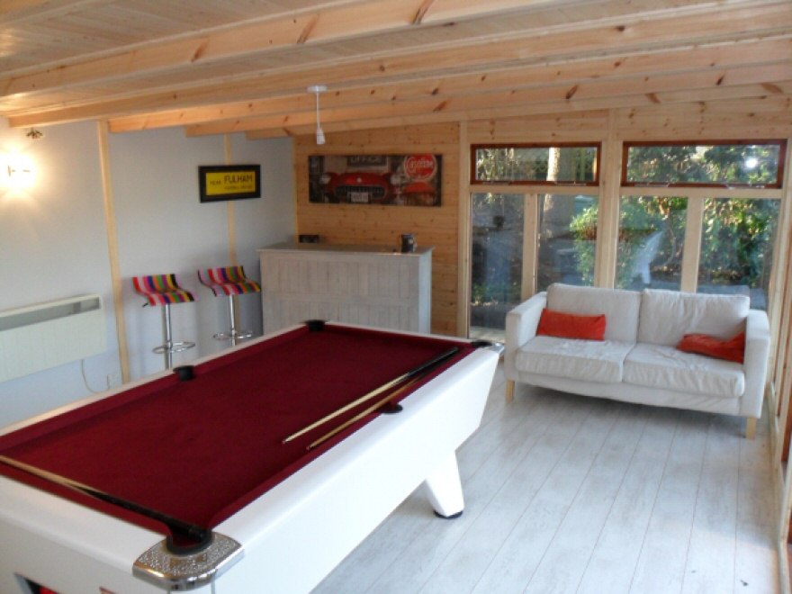 Pool table with bar and sofa