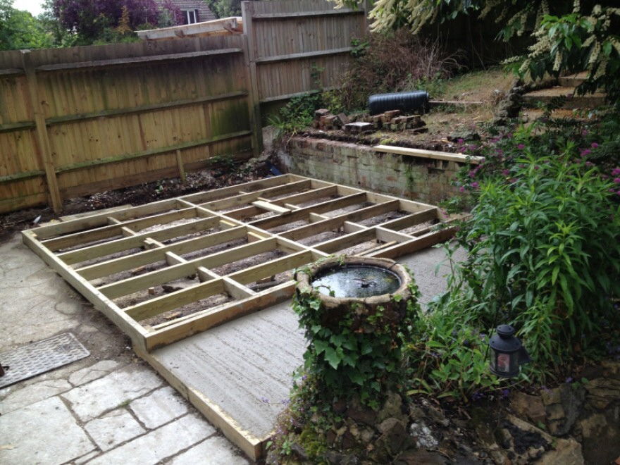 Timber frame base on concrete with patio sub-base & old retaining wall